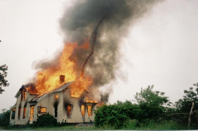 Superheated gasses!
The intense heat creates it's own wind from the rapid rushing-in of the surrounding oxygen.  Notice the heat vortex rising from the peak.  Photo courtesy of 'Sonny Day Photo'